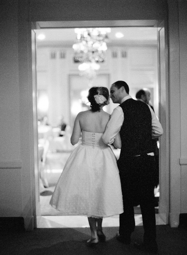 Couple walking into reception in black and white - wedding photo by top Austin based wedding photographers Q Weddings